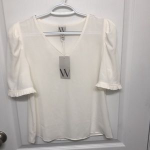 New With Tags. Sheer XS blouse. Two small imperfections. Beautiful blouse.